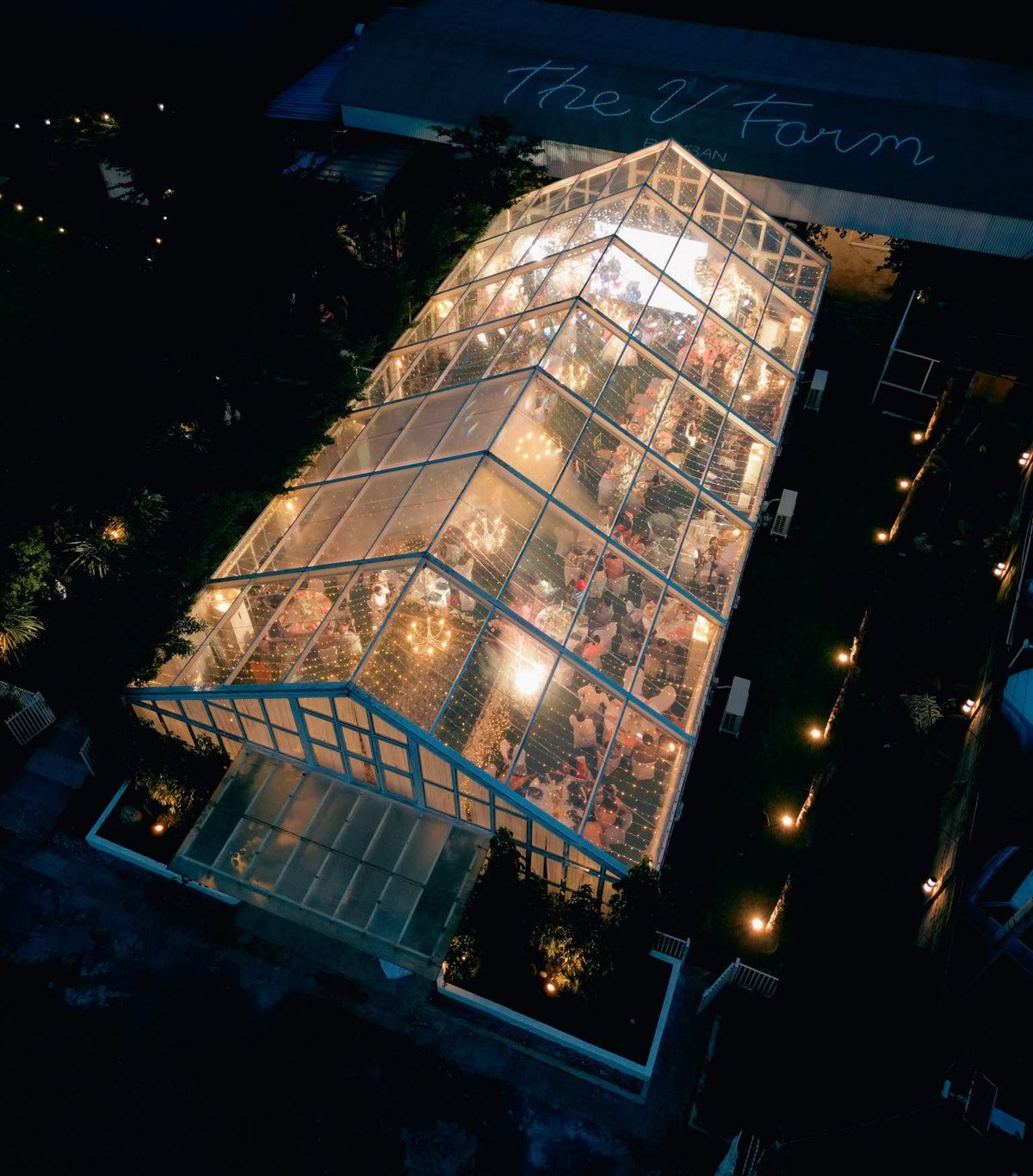 Aerial view of The Shed at The VFarm Bamban, lit up at night